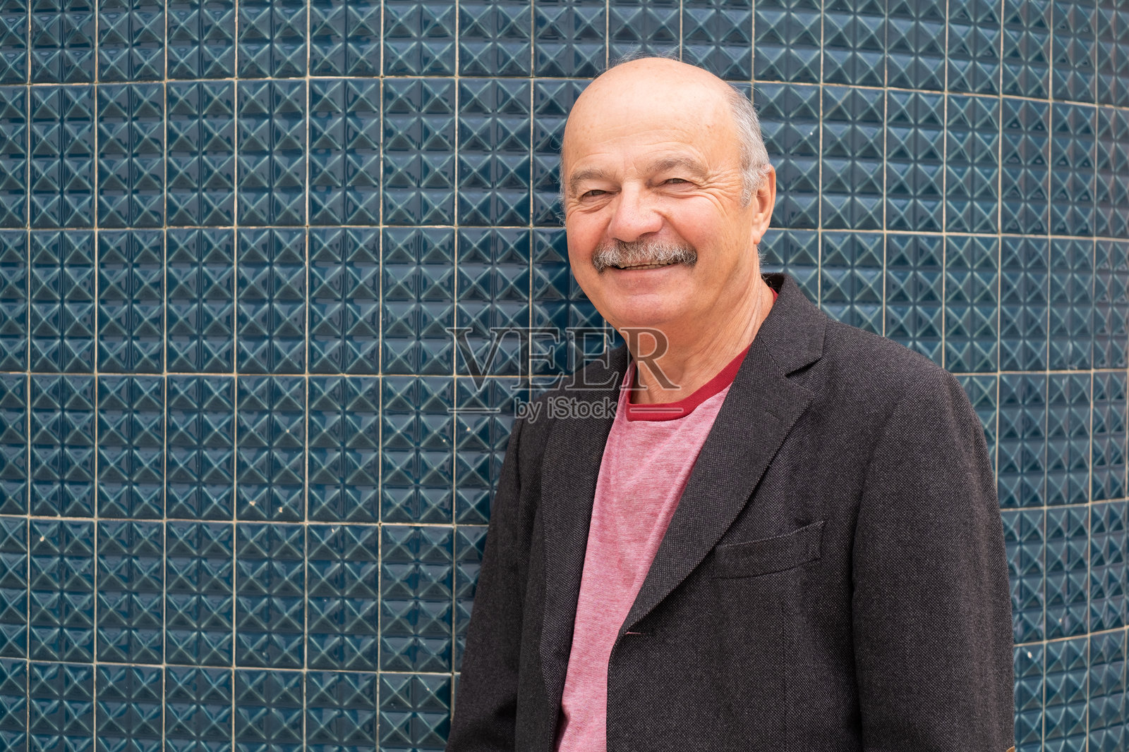 留着胡子的老人微笑着走在葡萄牙狭窄的街道上照片摄影图片