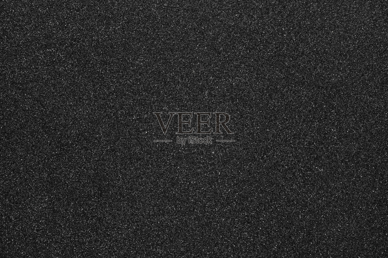 黑色闪光创造出纹理、闪闪发光的表面。背景提供闪亮、抽象和金属质感，适用于设计照片摄影图片