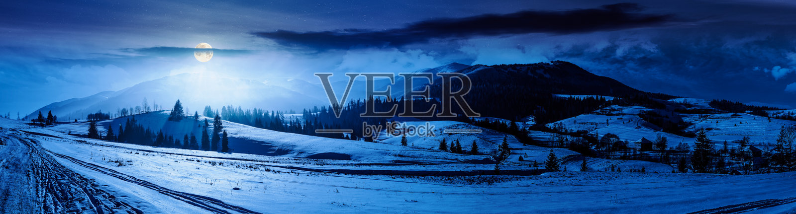 夜晚时分，山谷中的森林靠近村庄照片摄影图片