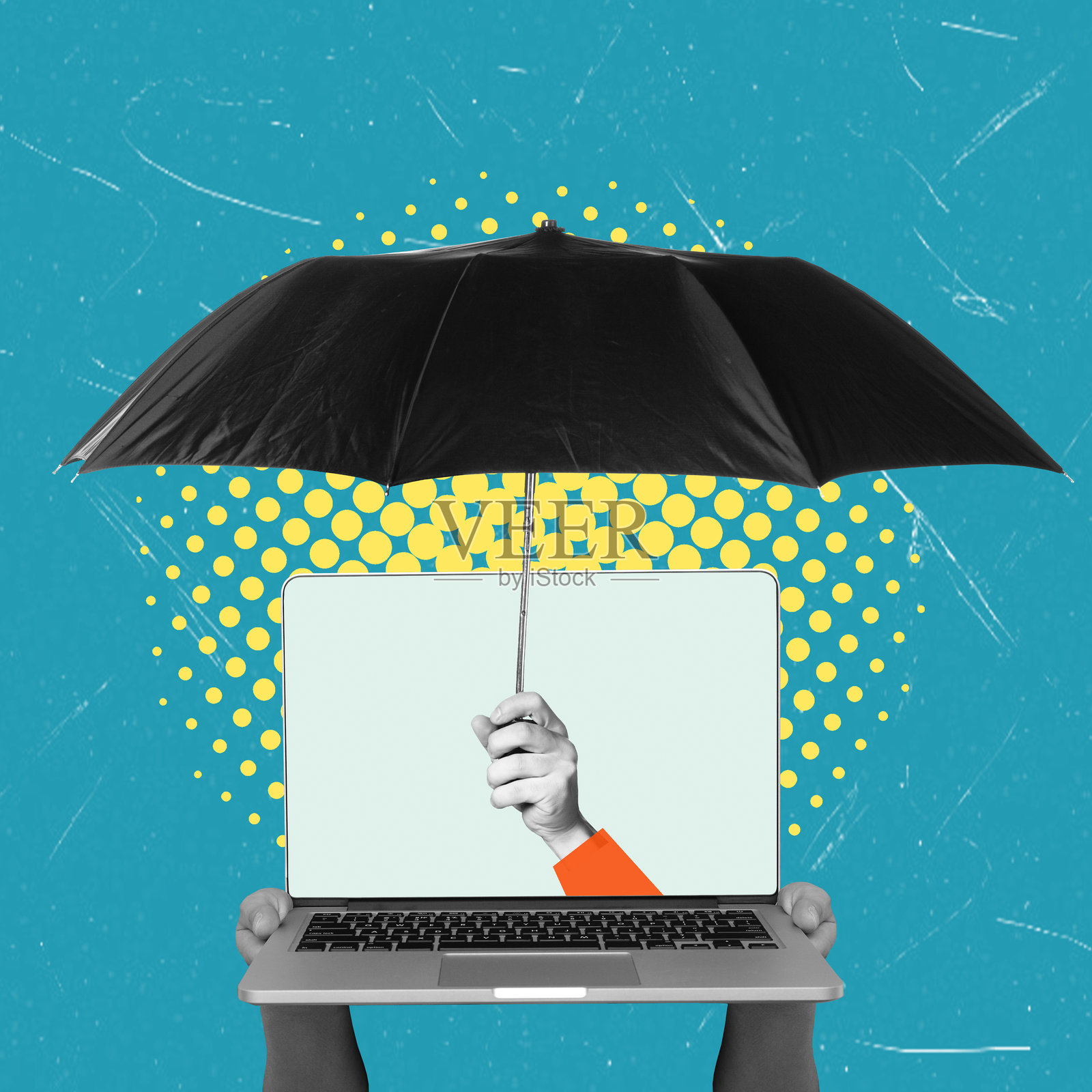 一只手打着伞保护着笔记本电脑的创意概念，象征着数字工作空间的保护和创新照片摄影图片