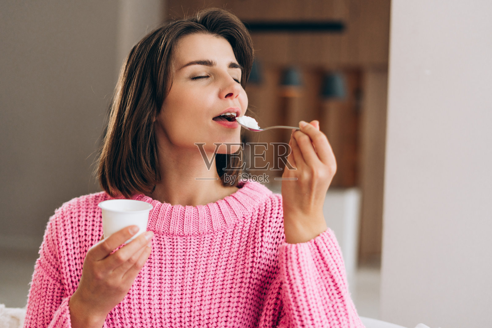 年轻女子在家享用健康的酸奶零食照片摄影图片