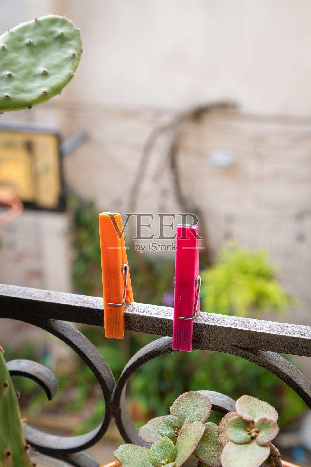 色彩鲜艳的晾衣夹挂在华丽的阳台栏杆上照片摄影图片