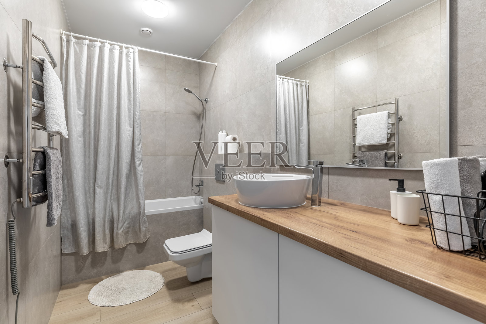 带木质台面和电动毛巾烘干机的现代浴室照片摄影图片