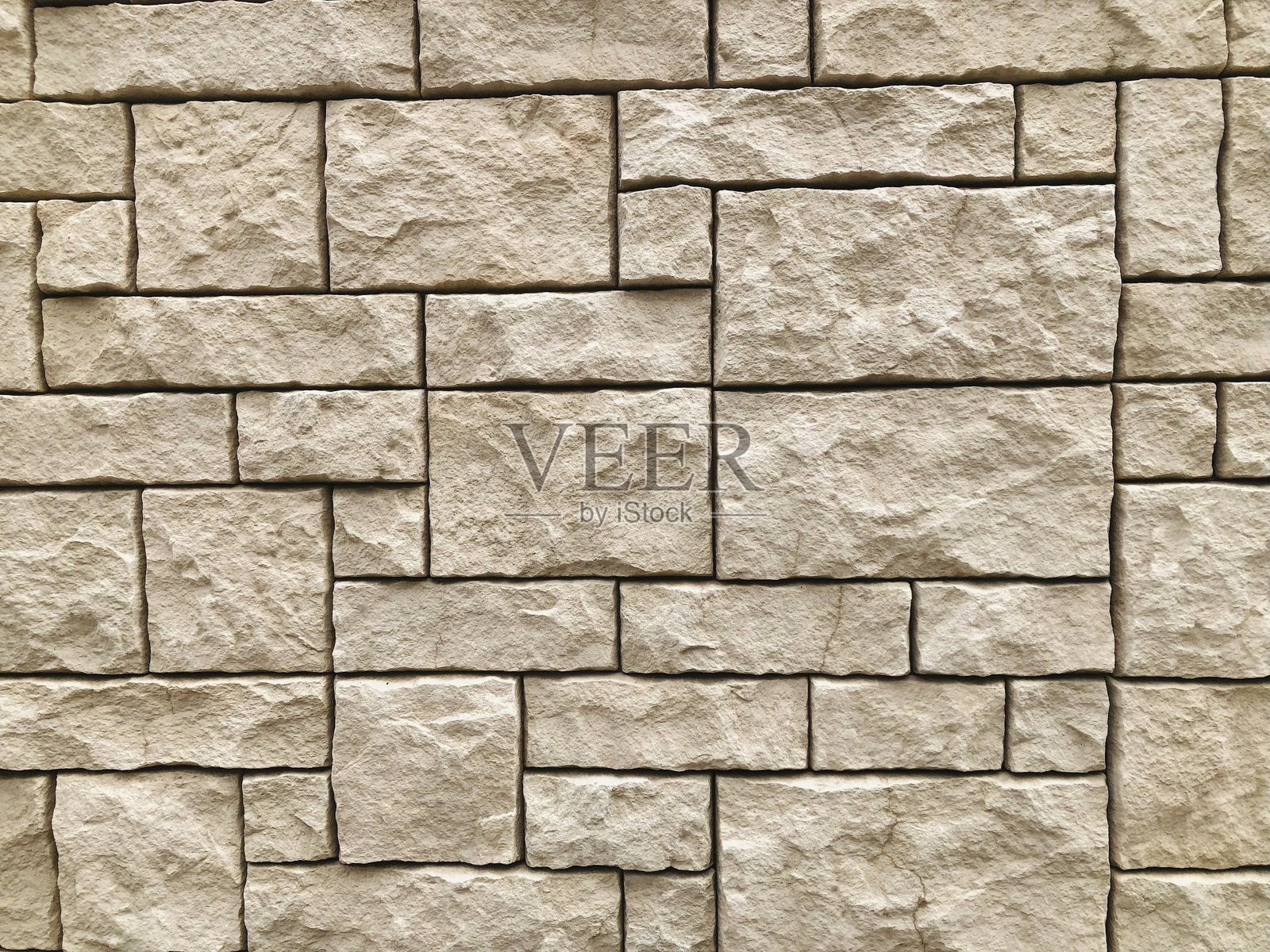 镶嵌着大小不一的白色方石的外墙背景照片摄影图片