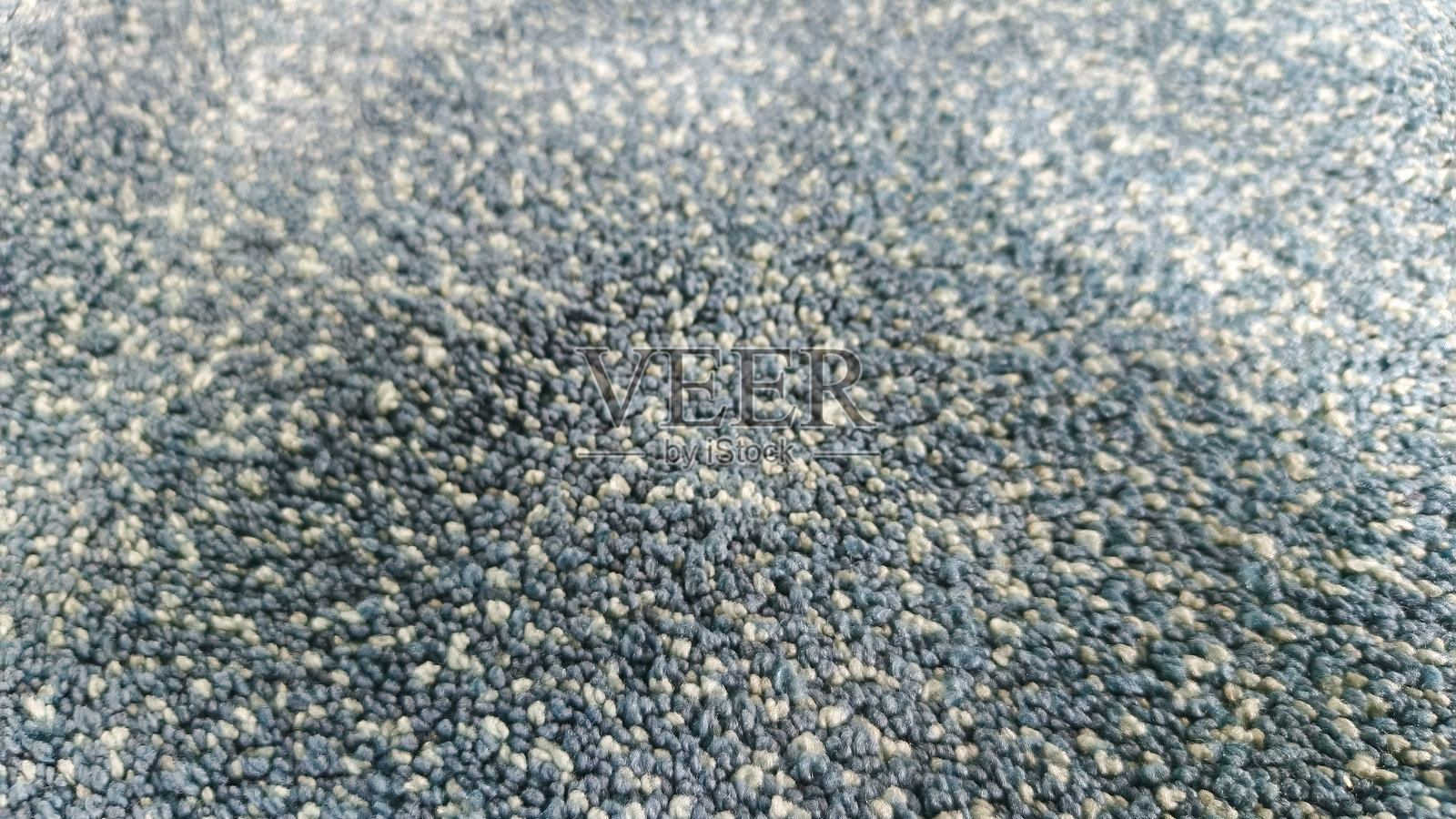 地毯或地垫纹理的极端微距视图，具有浅景深。抽象的颗粒状背景，适用于纺织品、织物或地板概念。照片摄影图片