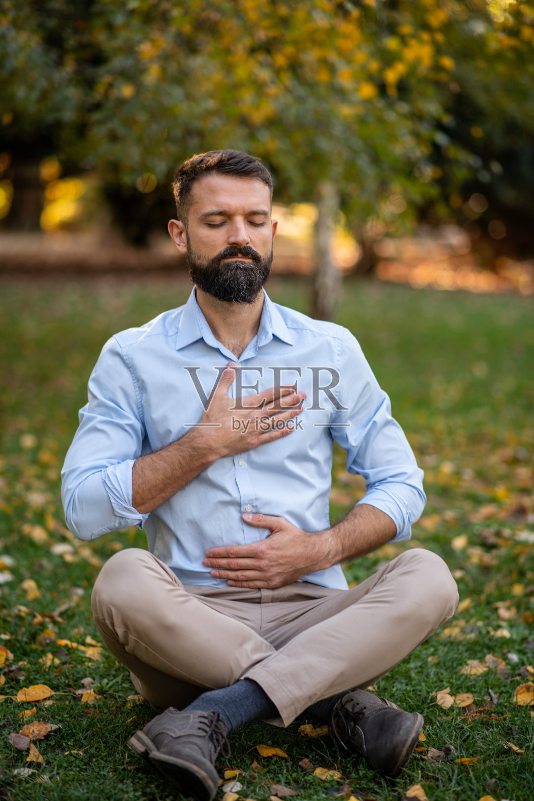 商人正在公园里做呼吸练习照片摄影图片