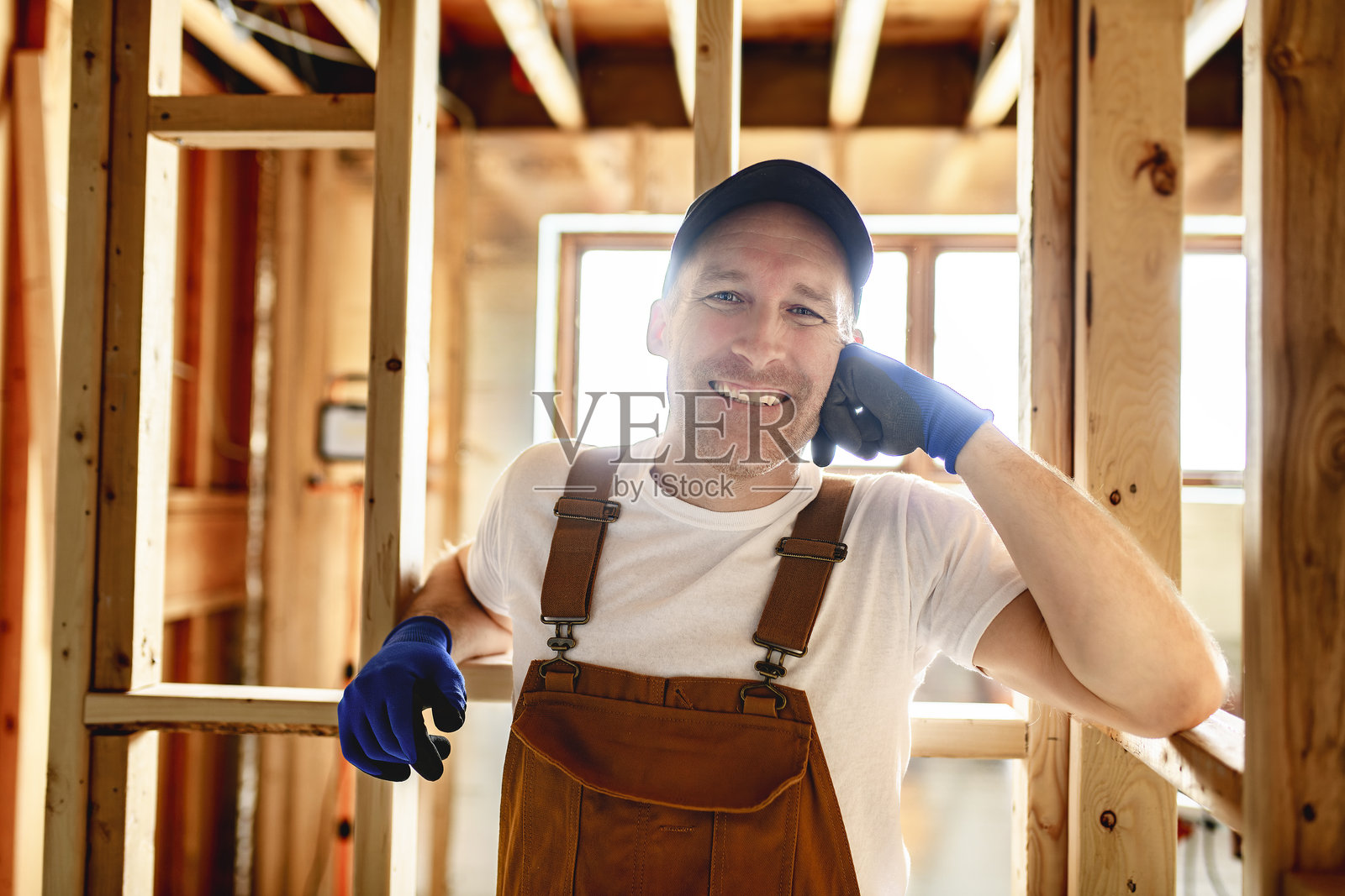新房未完工的地下室里，一名建筑工人正在使用电动工具照片摄影图片