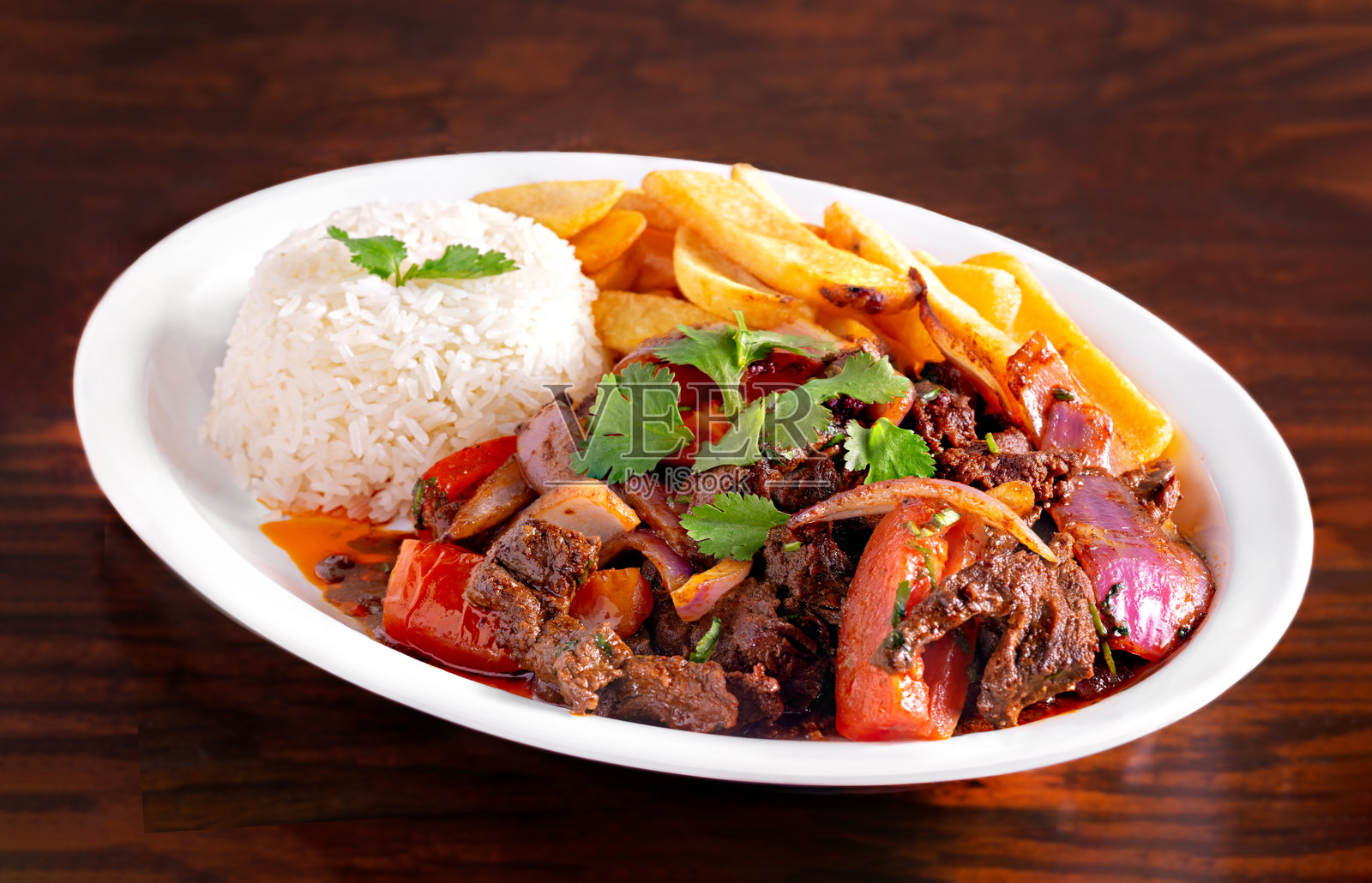 秘鲁牛肉配烤蔬菜、米饭和木薯薯条照片摄影图片