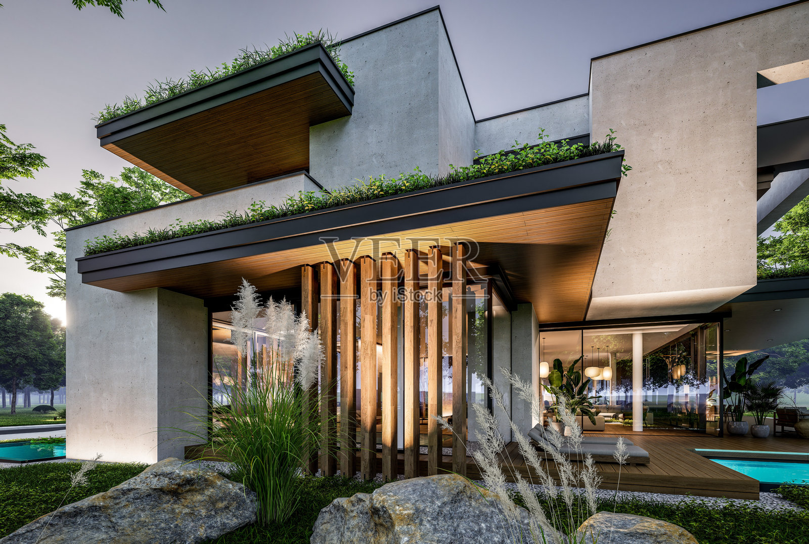 两层楼的混凝土外观房屋的 3D 渲染图，摄于夜晚照片摄影图片