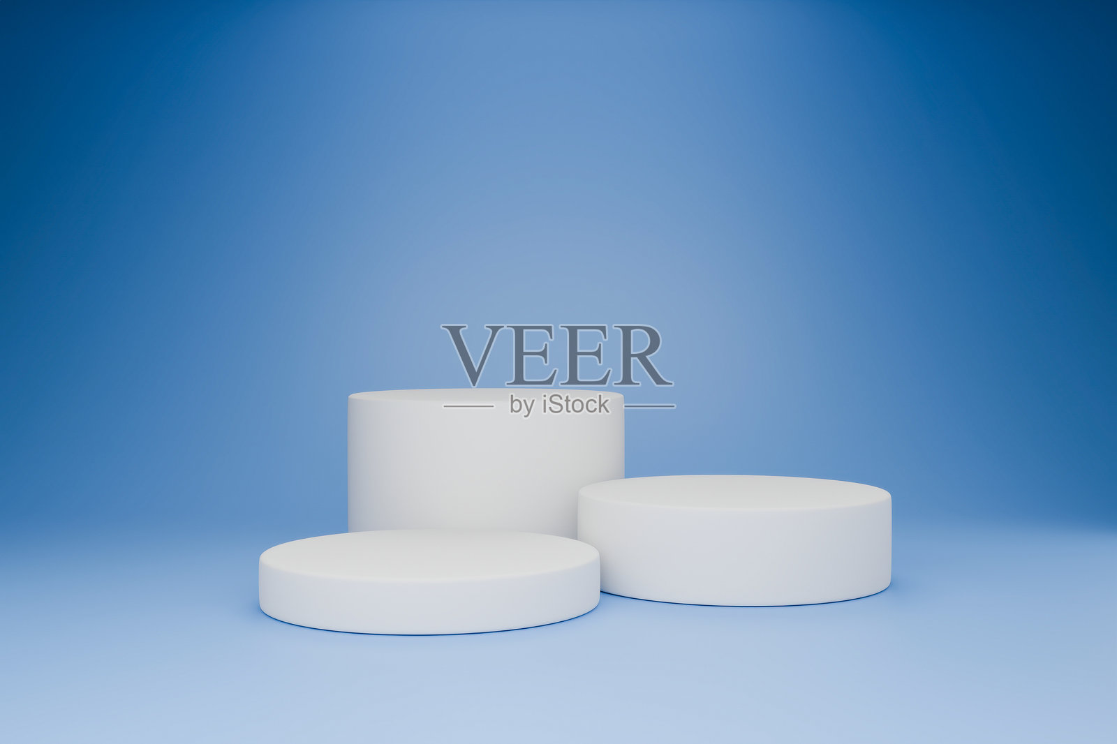 白色的圆柱形物体放置在蓝色背景上照片摄影图片