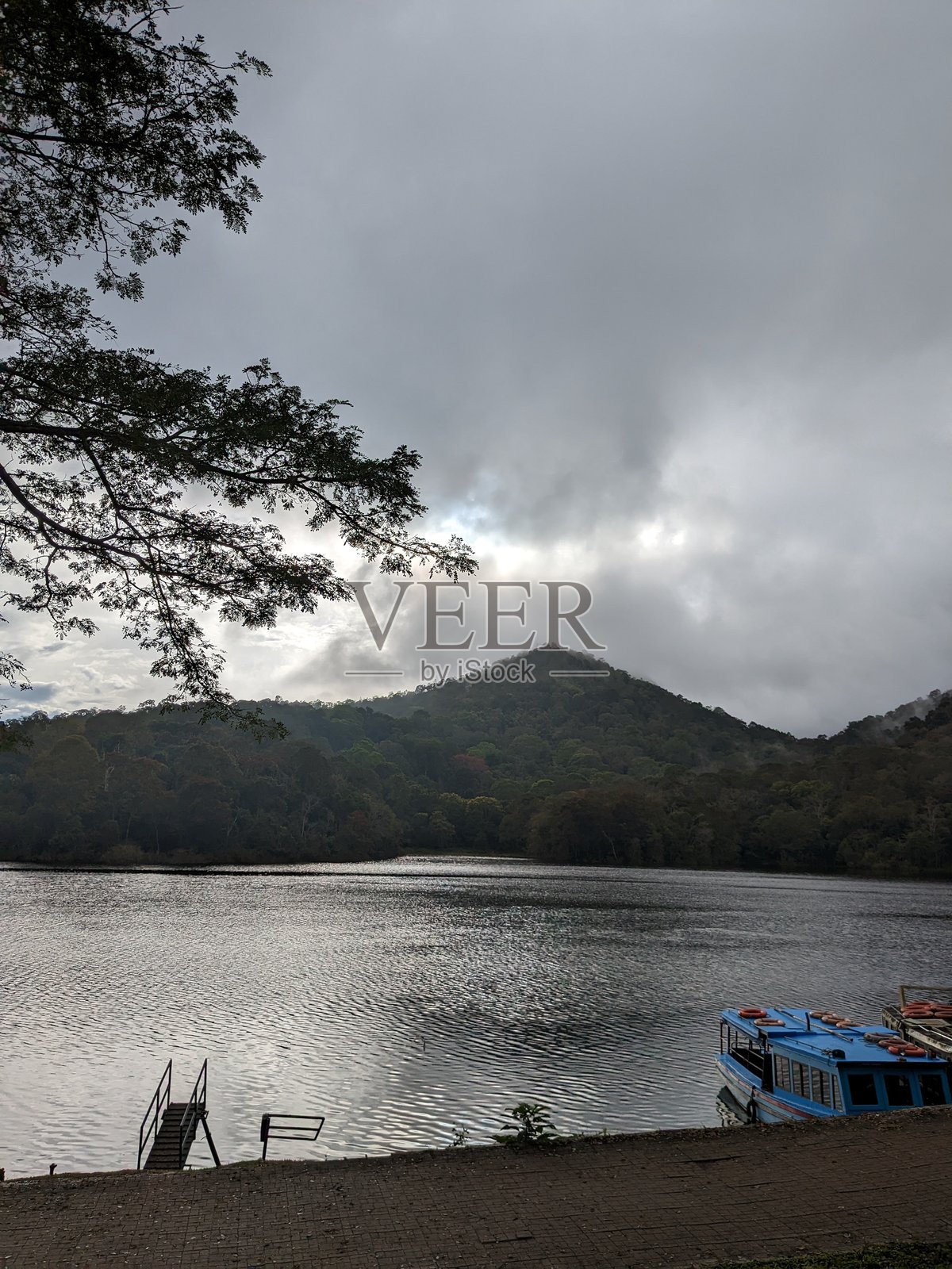 湖畔码头，蓝船与山峦剪影照片摄影图片