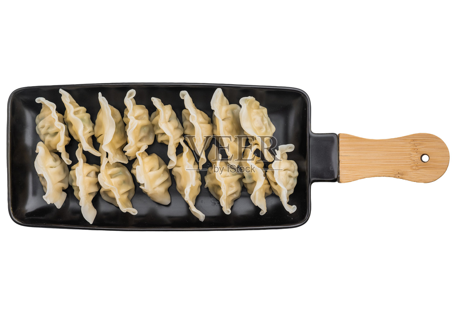 柔软褶皱的亚洲饺子，内馅鲜美，盛放在深色盘子上，俯视拍摄，非常适合用作图库图片和菜单设计。照片摄影图片