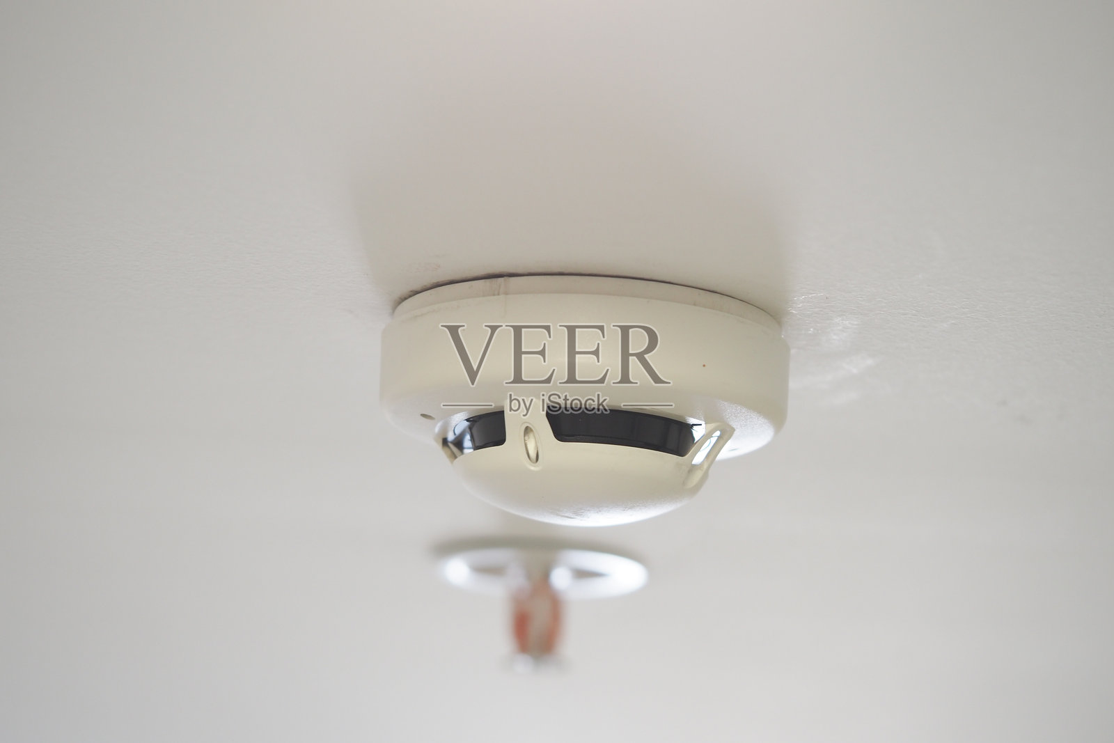 安装在住宅空间天花板上的烟雾探测器照片摄影图片