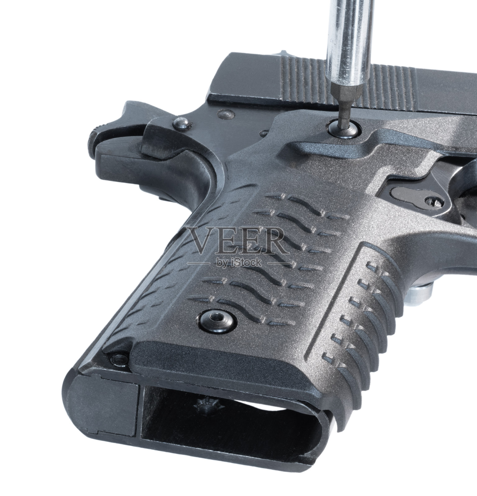 用工具拧紧手枪握把上的第二个螺栓照片摄影图片