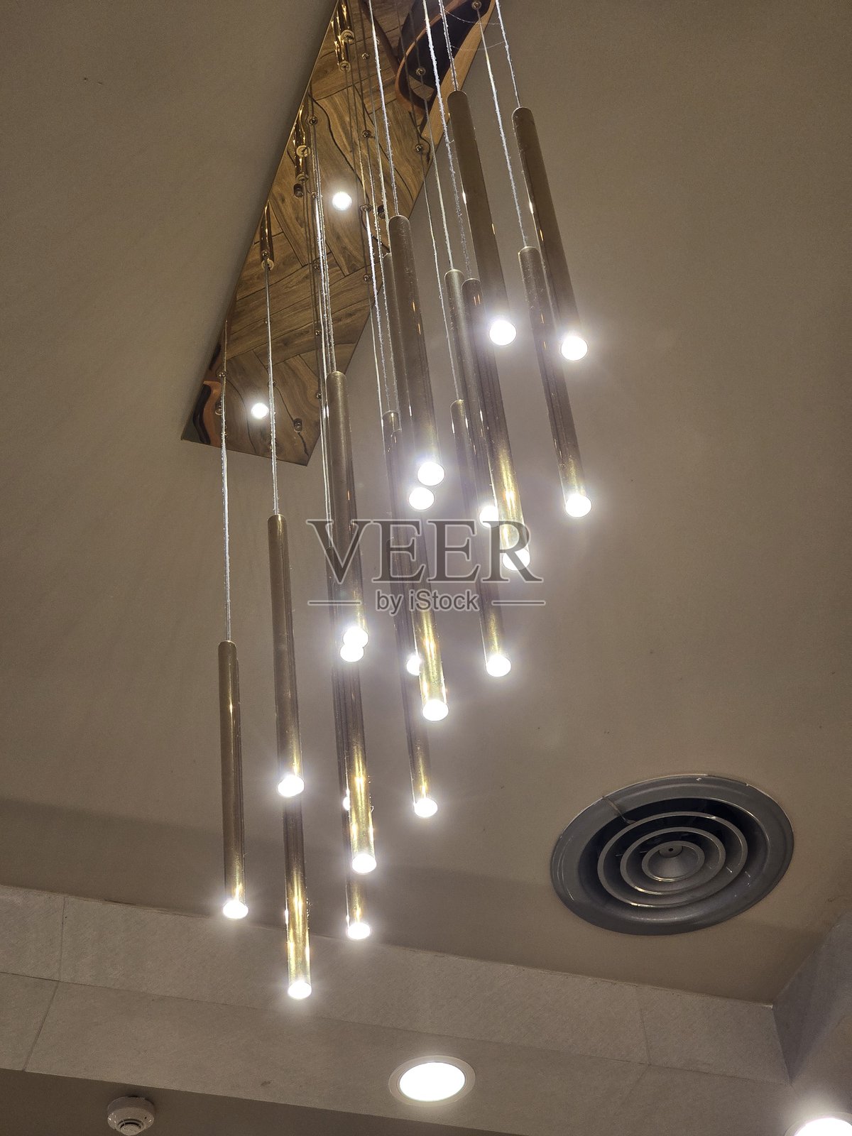 现代优雅的吊灯在当代空间中散发出温暖的光芒照片摄影图片