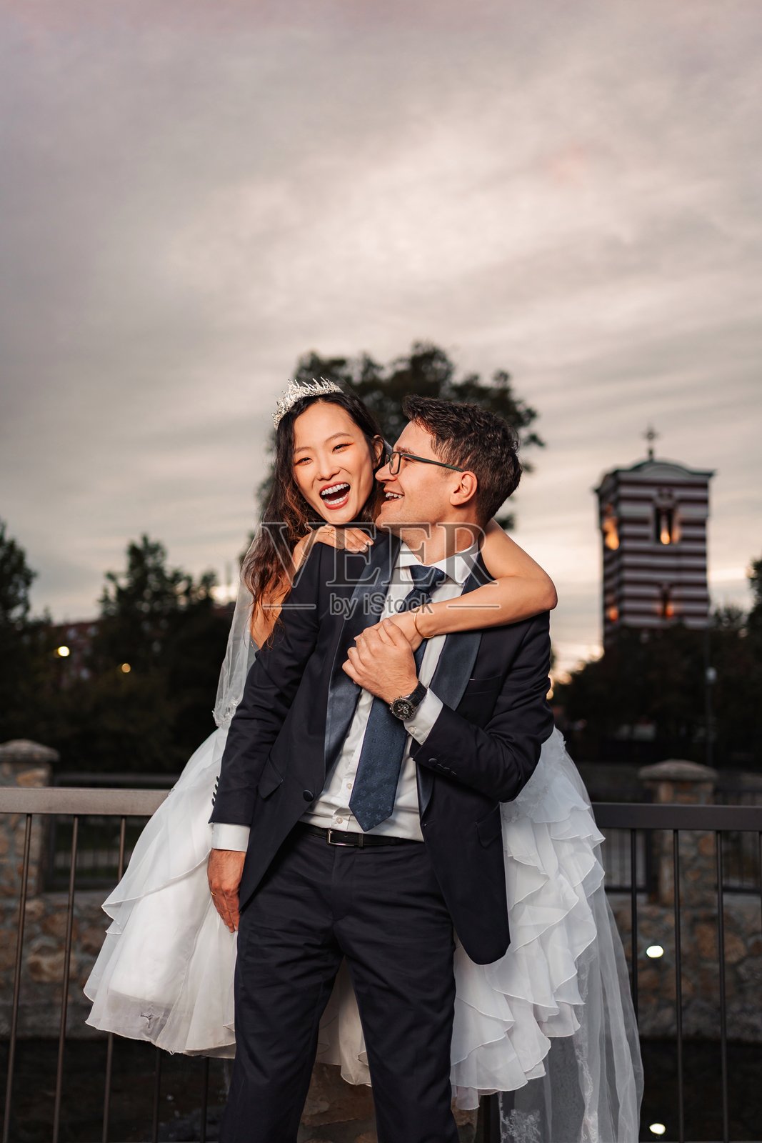 一对快乐的跨种族情侣在户外享受婚礼日照片摄影图片