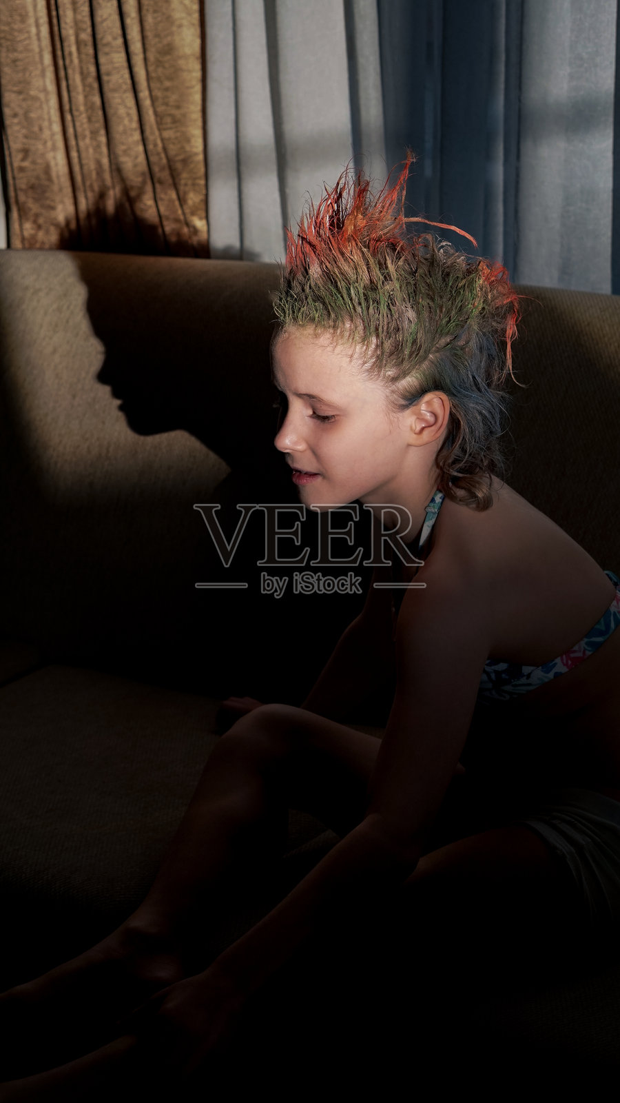 聚光灯下的珊瑚色莫西干发女孩剪影照片摄影图片