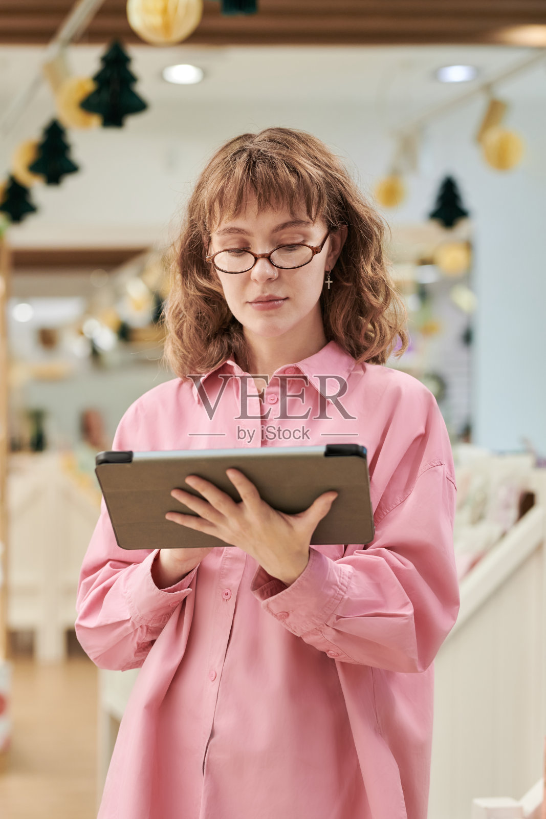 年轻女子在室内使用数码平板电脑照片摄影图片