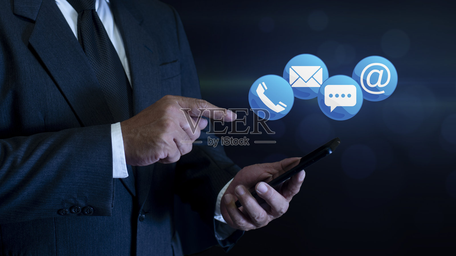商人使用智能手机，上面有联系信息符号（地址、电话、电子邮件、手机、呼叫）。联系客户支持。联系我们概念照片摄影图片