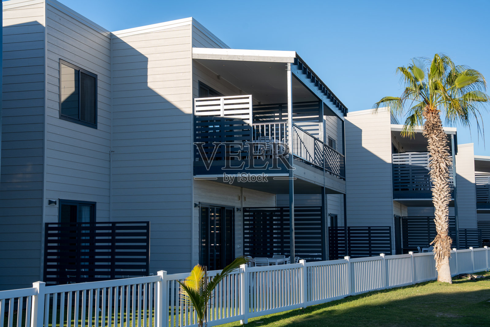 澳大利亚宁加洛海洋公园海岸线上宁静的小型度假村珊瑚湾，拥有度假村设施、海滨餐厅和渔船照片摄影图片