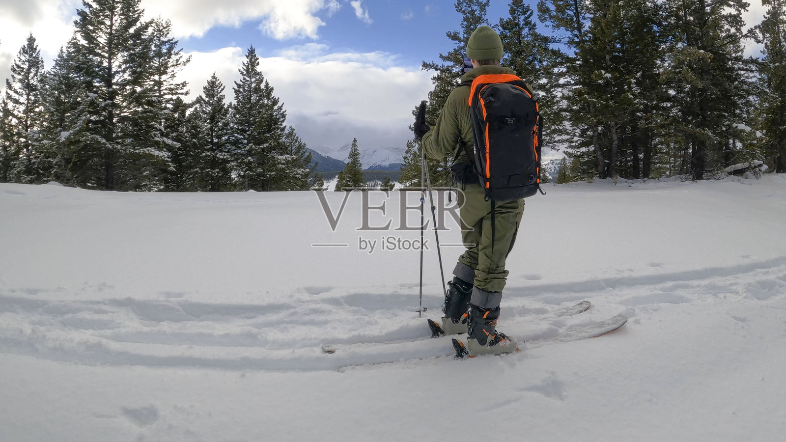 年轻男子在森林中准备进行野雪滑雪照片摄影图片