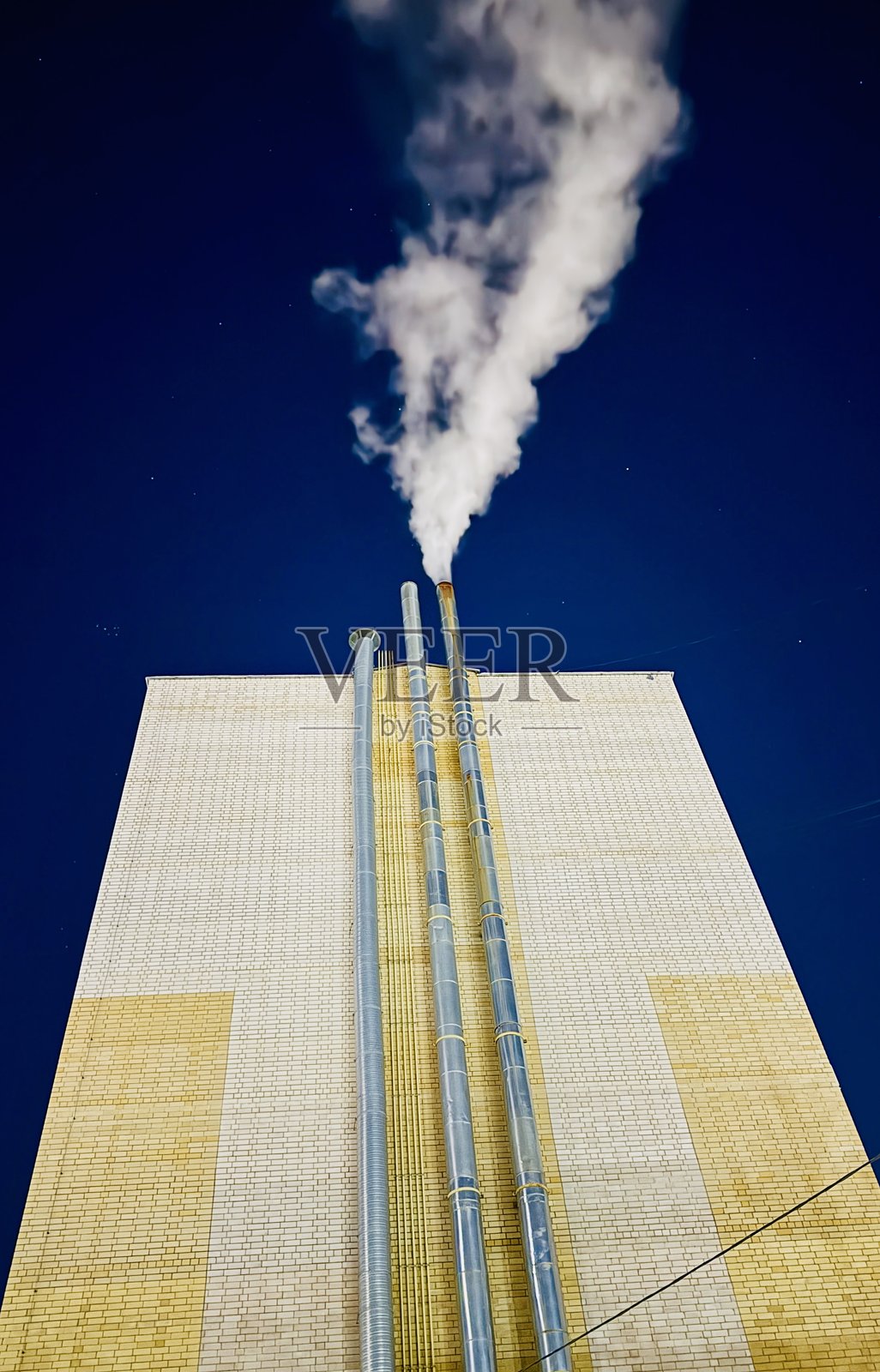 工业夜景，夜晚工厂排烟，暮光天空下有蒸汽升腾的城市工厂，深蓝色天空下制造厂释放废气的夜景照片摄影图片