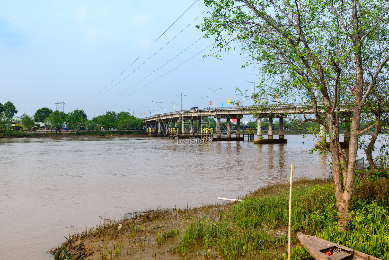 越南芹苴市的混凝土桥跨越泥泞的河流照片摄影图片