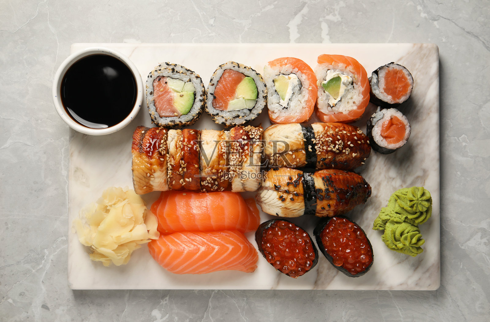 浅灰色大理石桌上的美味寿司卷，俯视角度照片摄影图片