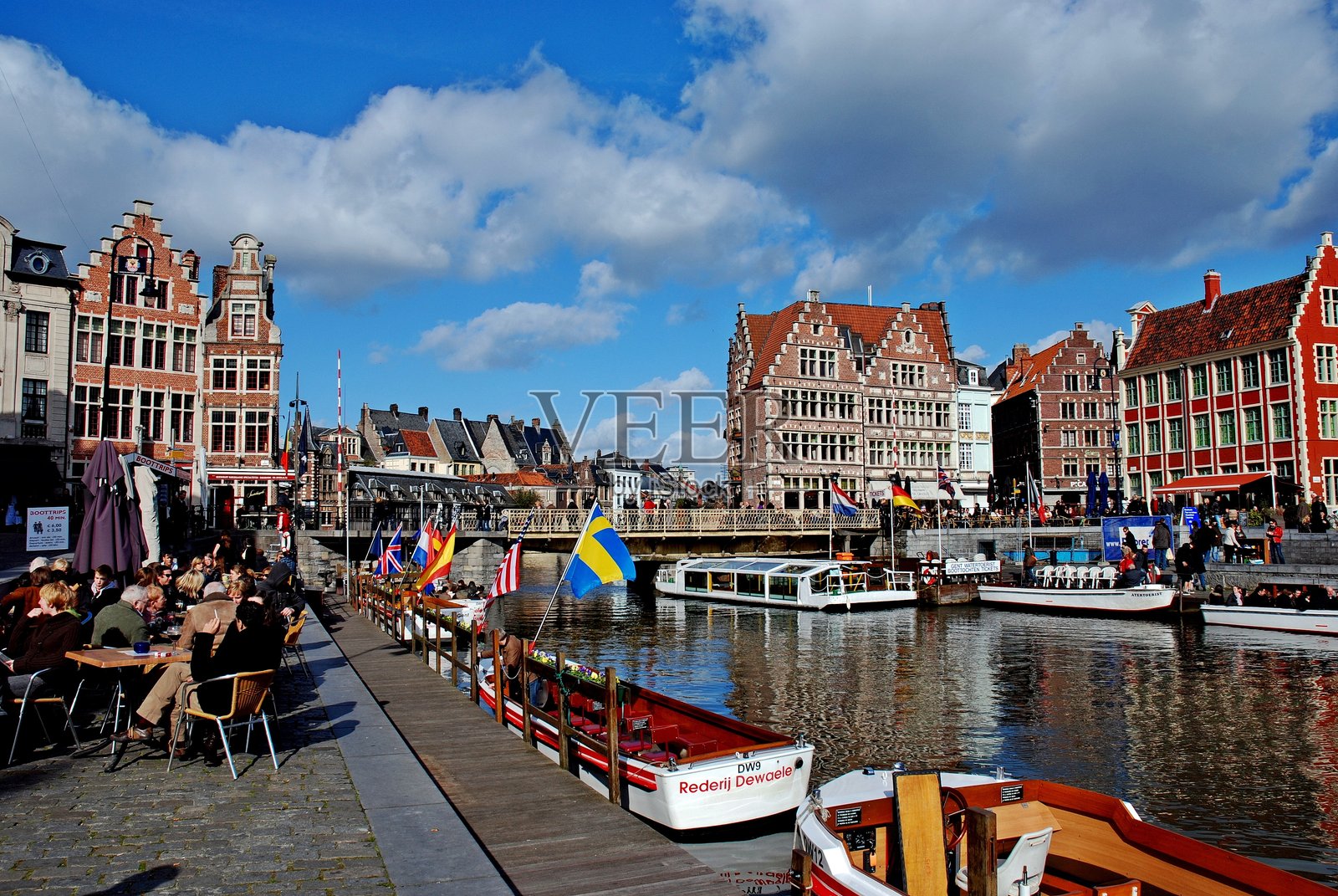 阳光明媚的格拉斯雷码头午后：历史悠久的根特船只与运河边的社交生活照片摄影图片