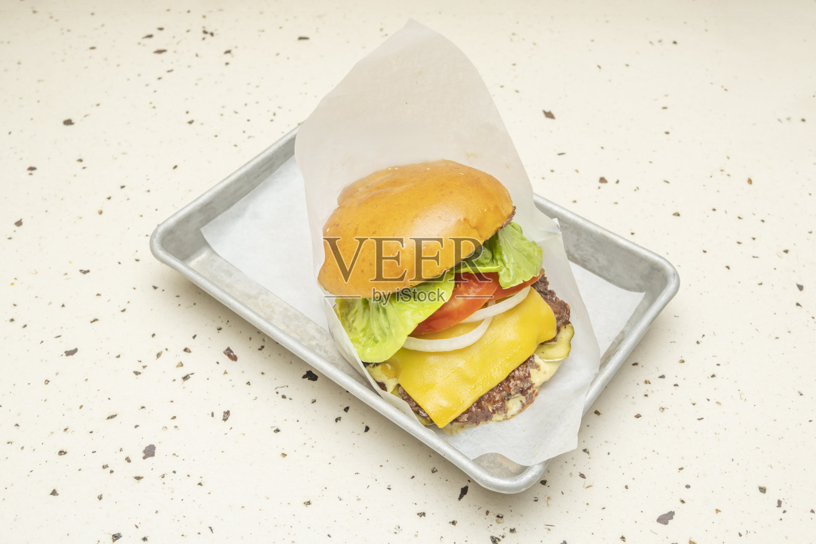 三种肉混合的美味汉堡，搭配融化的哈瓦提奶酪、新鲜番茄和生菜，夹在黄油布里欧修面包中照片摄影图片