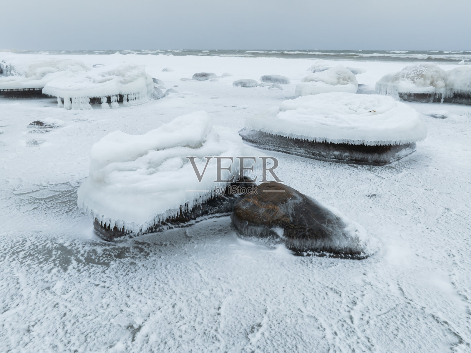 冬季，爱沙尼亚覆盖着雪的波罗的海沿岸，有冰冷的岩石、冰冻的构造和冰柱。照片摄影图片