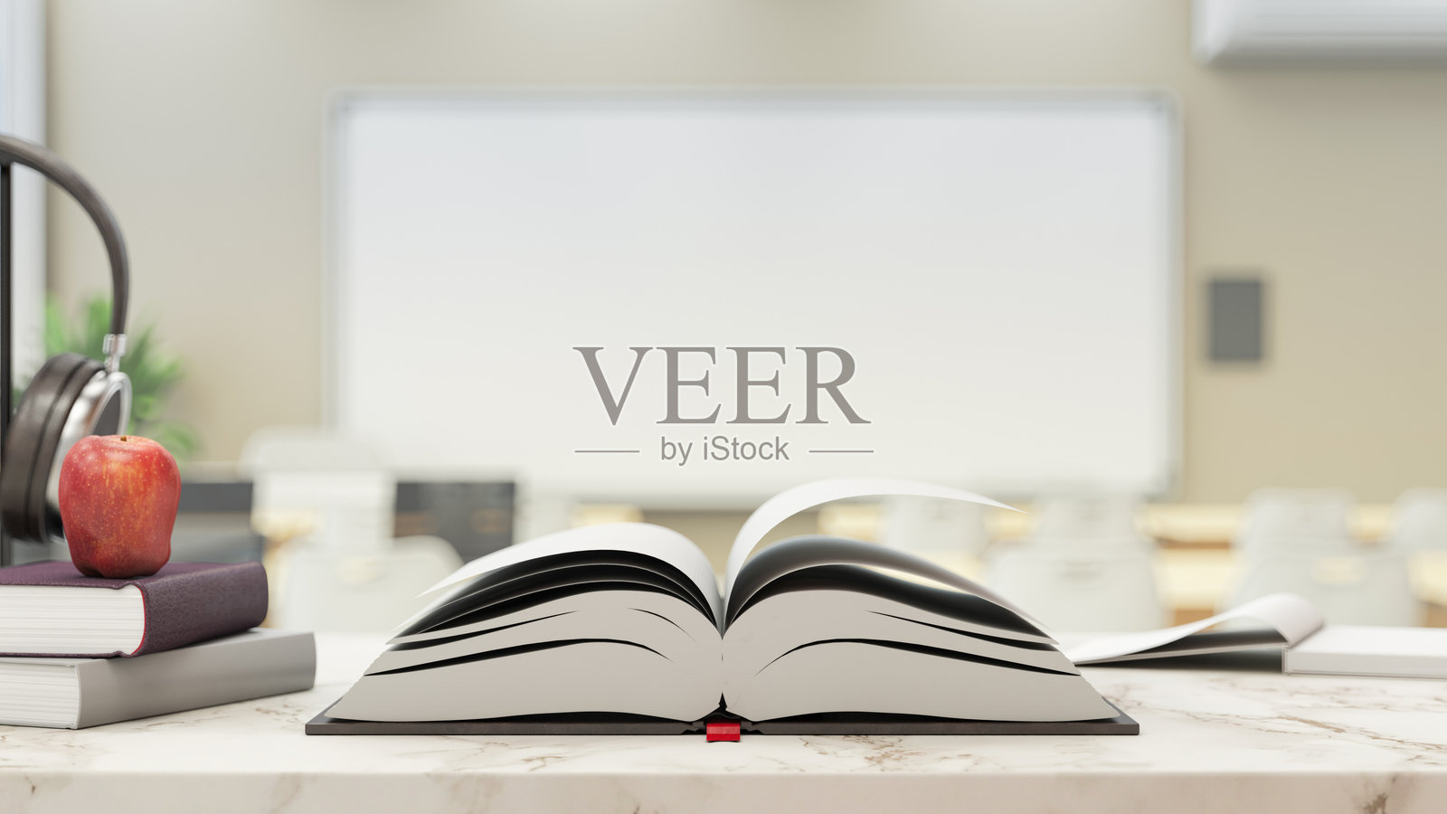 现代模糊教室书桌上的打开的书照片摄影图片