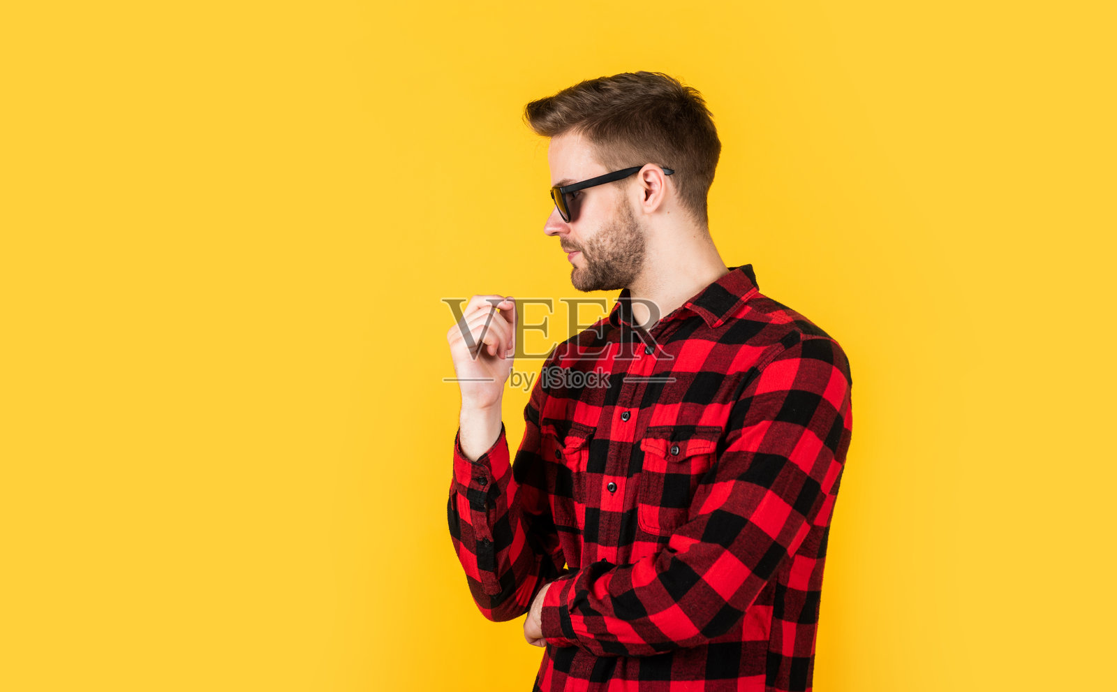 时尚美妆。理发店概念。男装。格子衬衫戴眼镜的年轻英俊男子。穿着休闲装的时尚男士。留着胡茬的胡须男。可爱时尚照片摄影图片