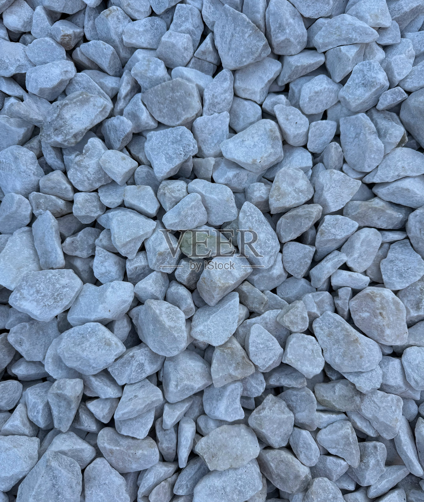 具有均匀、洁净质感的白色砾石图案。近景视角，展示了排列成无缝、重复图案的小而光滑的砾石。非常适合用作背景、表面和抽象设计。照片摄影图片