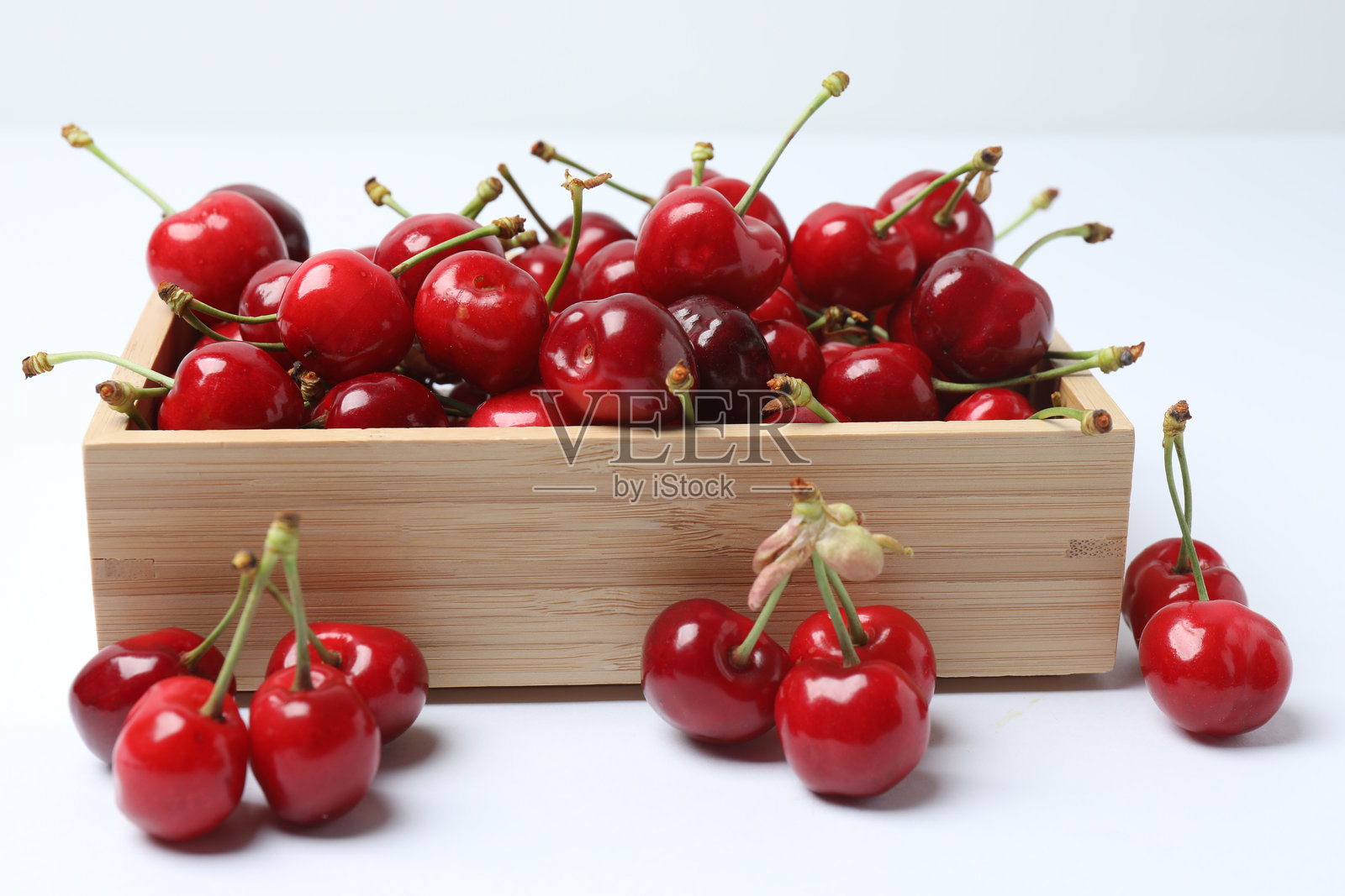 白色背景上的托盘里的樱桃照片摄影图片