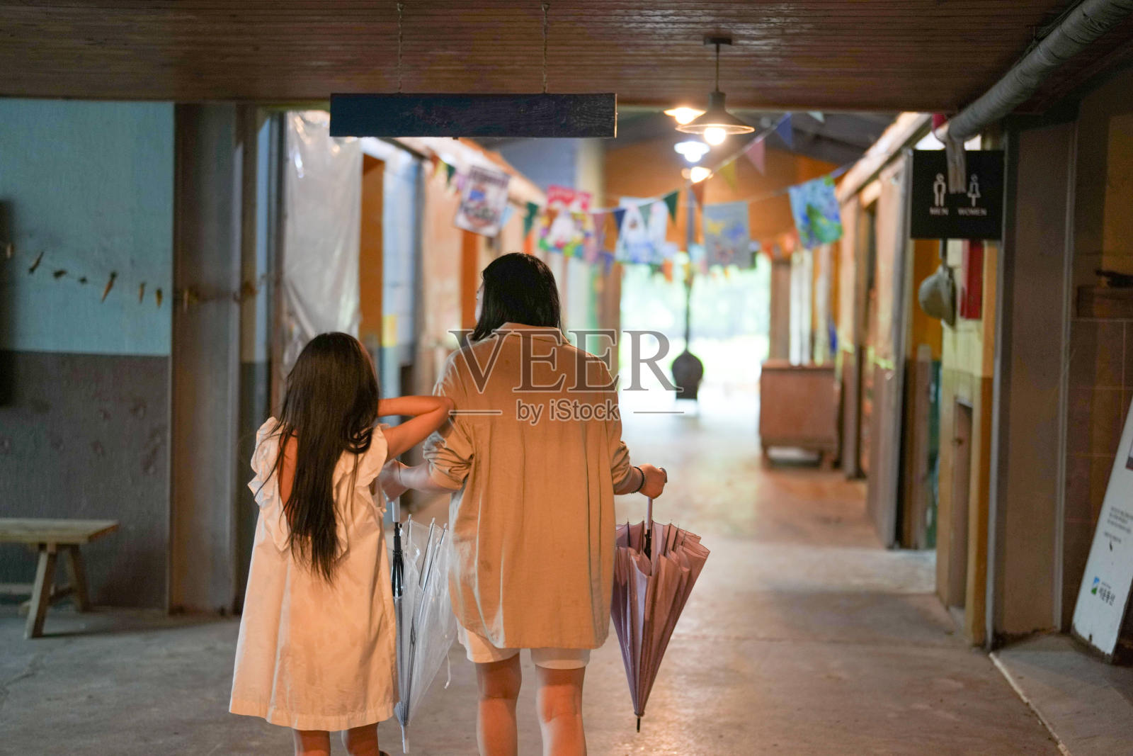 一位女士和一位孩子正走在走廊里照片摄影图片