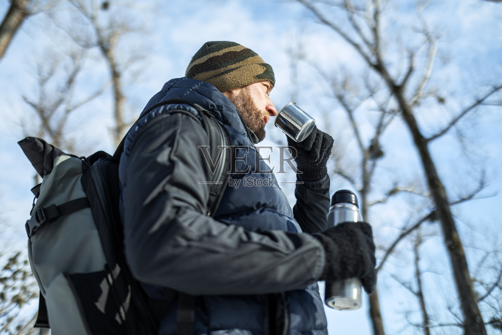 冬季徒步休息，饮用热饮照片摄影图片