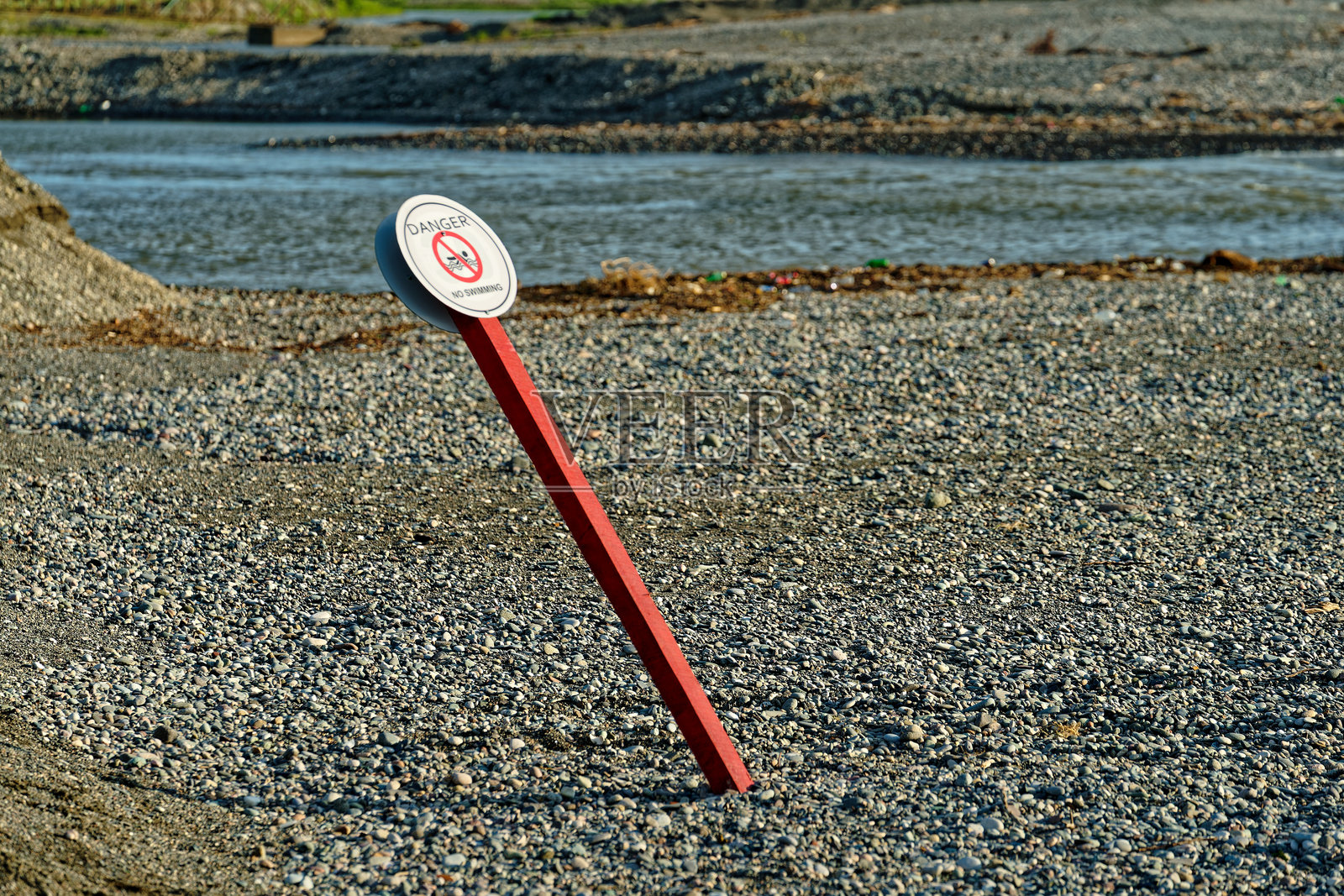 鹅卵石海滩上禁止游泳标志的俯视图照片摄影图片
