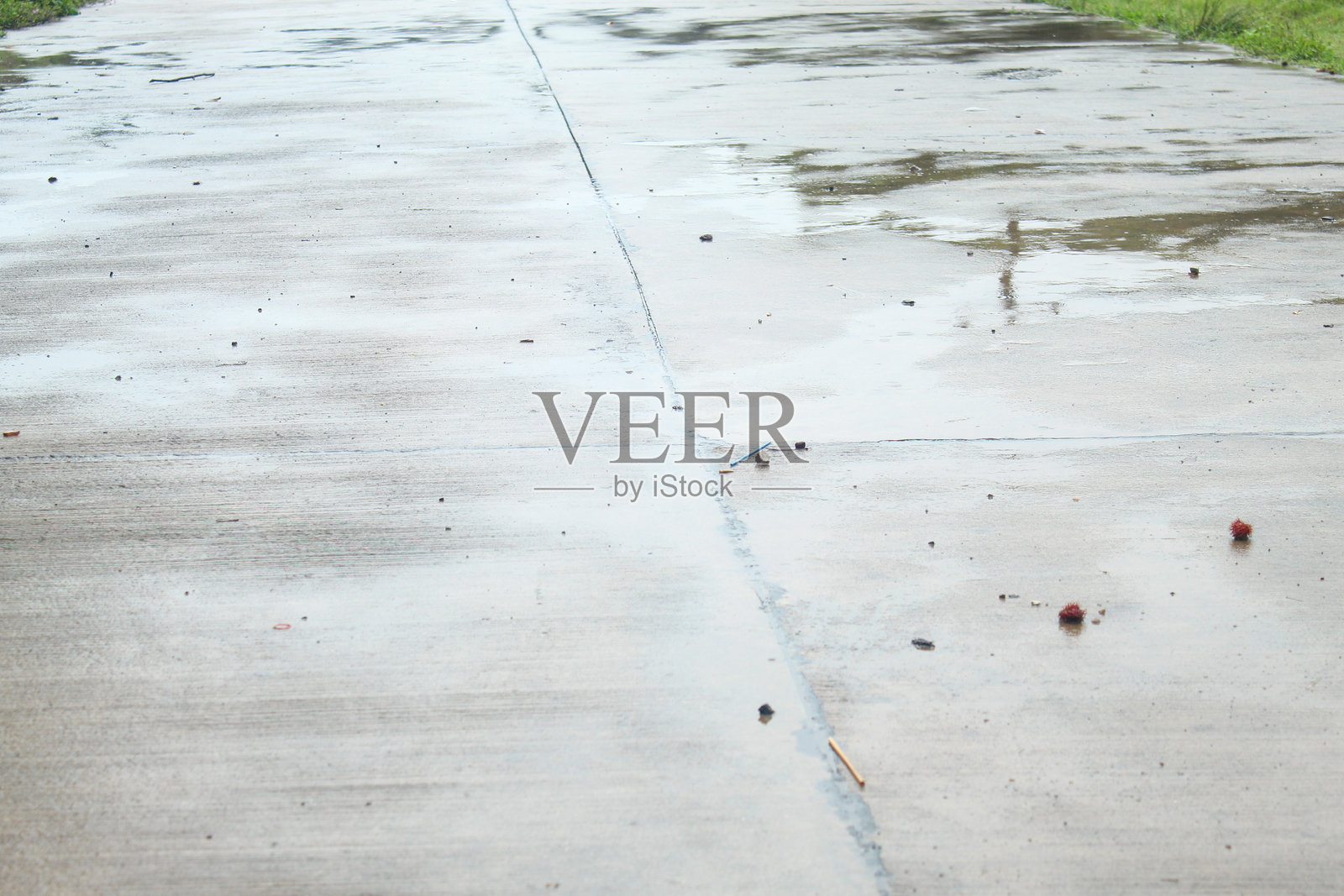 雨后湿漉漉的户外水泥路，水面上反射着光芒照片摄影图片