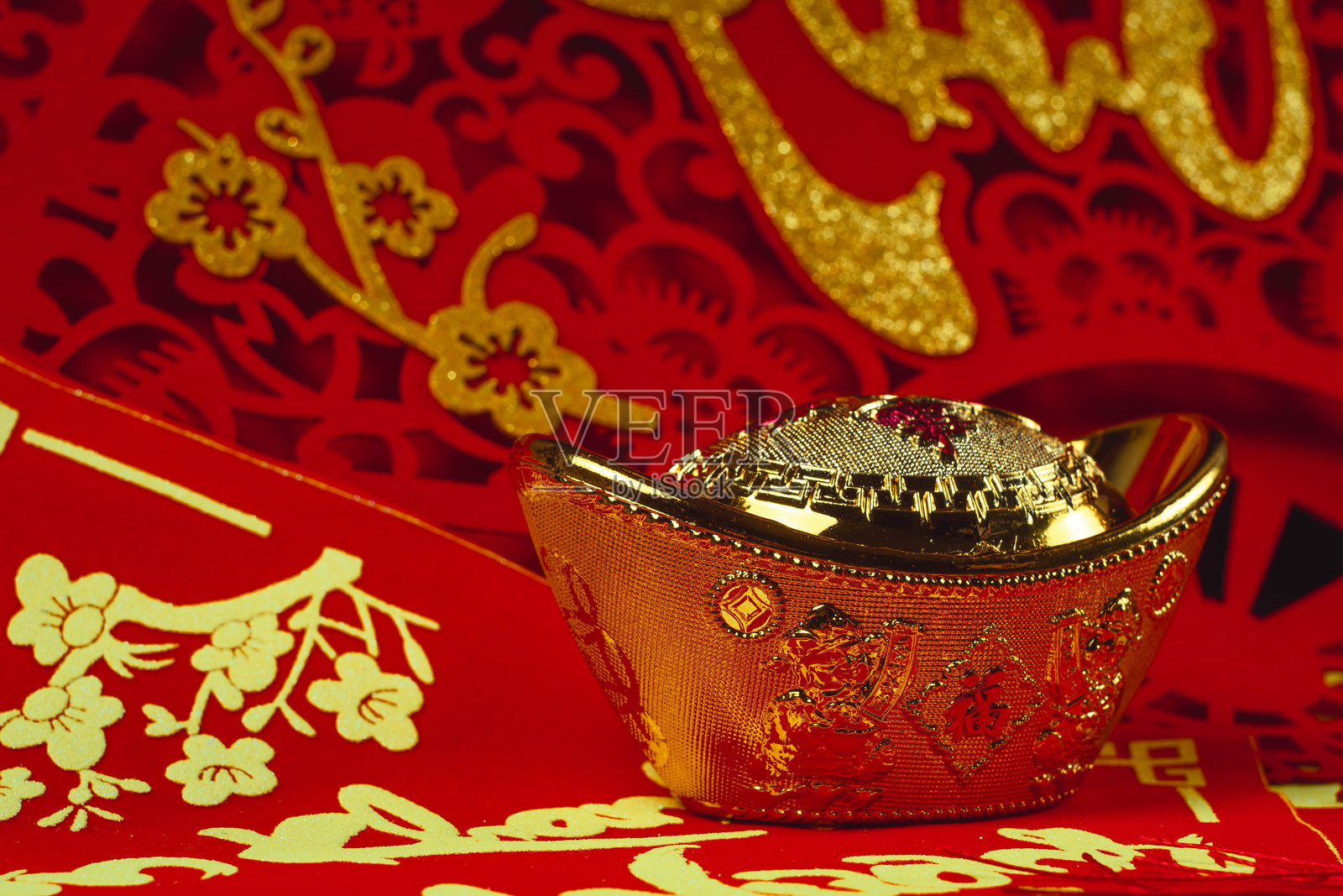 金色中国元宝和红色纸质新年装饰品照片摄影图片