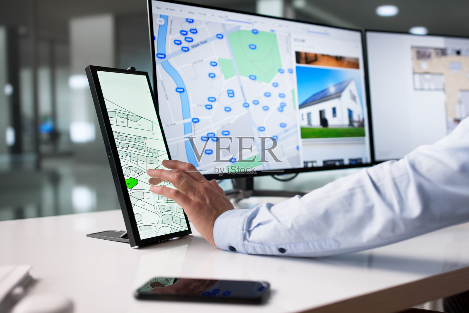 年轻男子在电脑上多任务处理，在线搜索房源照片摄影图片