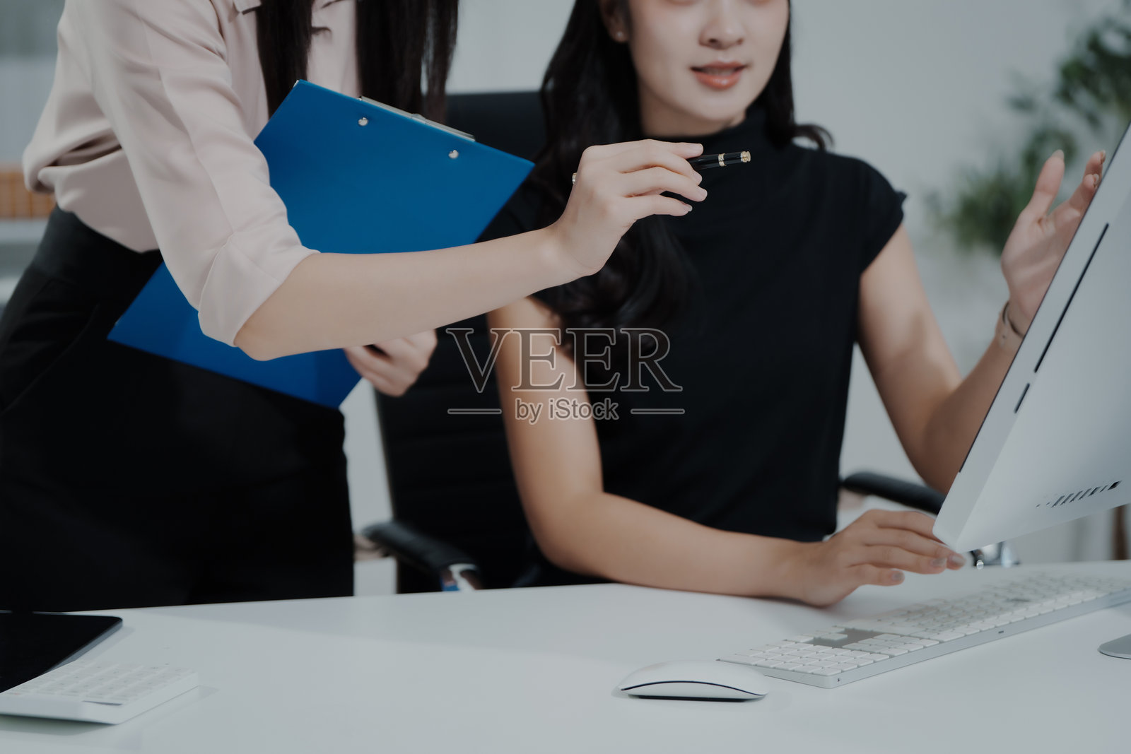 一位亚洲女商人正在办公桌前工作，分析数据，审阅报告，提供咨询，制定营销、财务和会计策略，专注于工作，专业，有条理，使用笔记本电脑。照片摄影图片