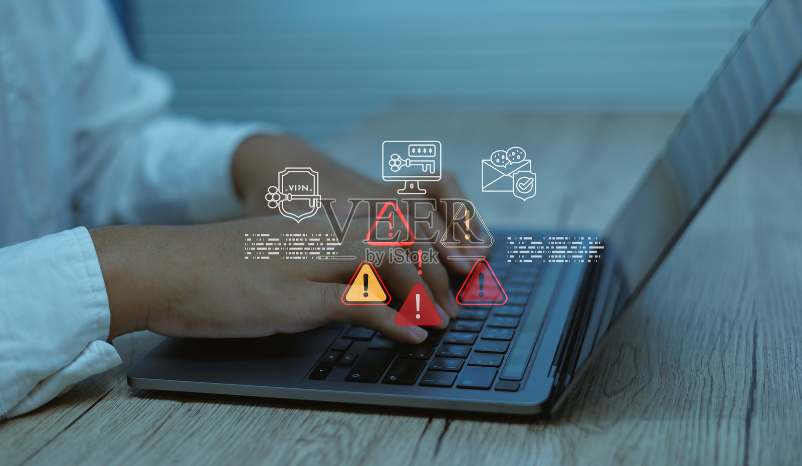 一名商人正在使用笔记本电脑打字，屏幕上显示数字警报图标、安全符号，概念涉及网络安全风险、系统错误、数据邮件保护、恶意软件检测和信息技术安全。照片摄影图片