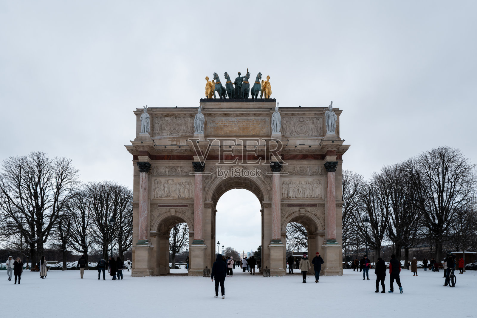 法国巴黎，卡鲁索凯旋门，有人和雪景。照片摄影图片