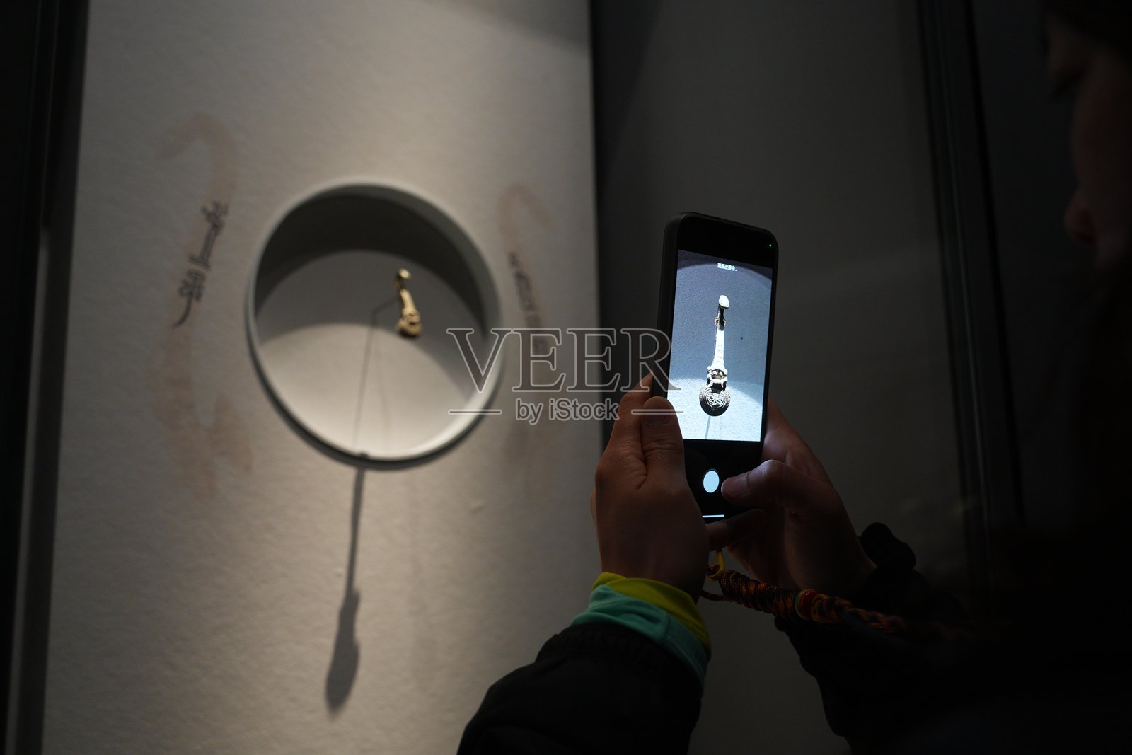 观众用手机拍摄展柜内古琴展品照片摄影图片