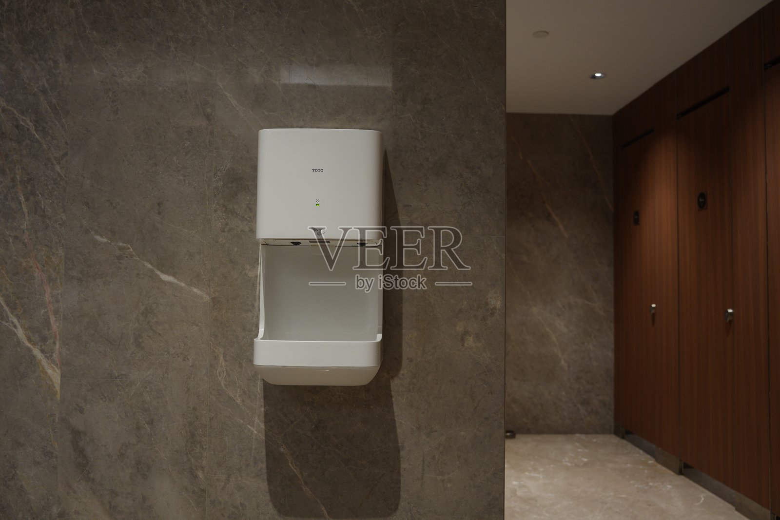 现代卫生间白色干手器安装于大理石墙照片摄影图片