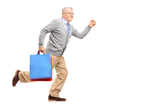 微笑的绅士跑着购物袋图片下载
