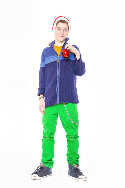 戴着圣诞老人帽的少年拿着圣诞球图片下载