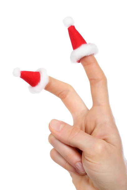 新年:戴着圣诞老人小帽子的手图片下载