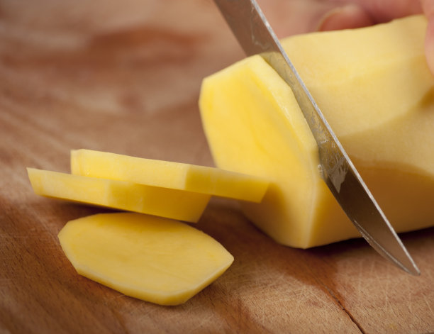 近距离切片土豆在木材背景图片下载